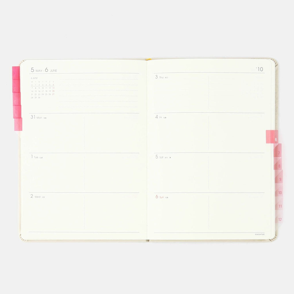Hightide See-Through Index Stickers, pink, on the edge of a planner