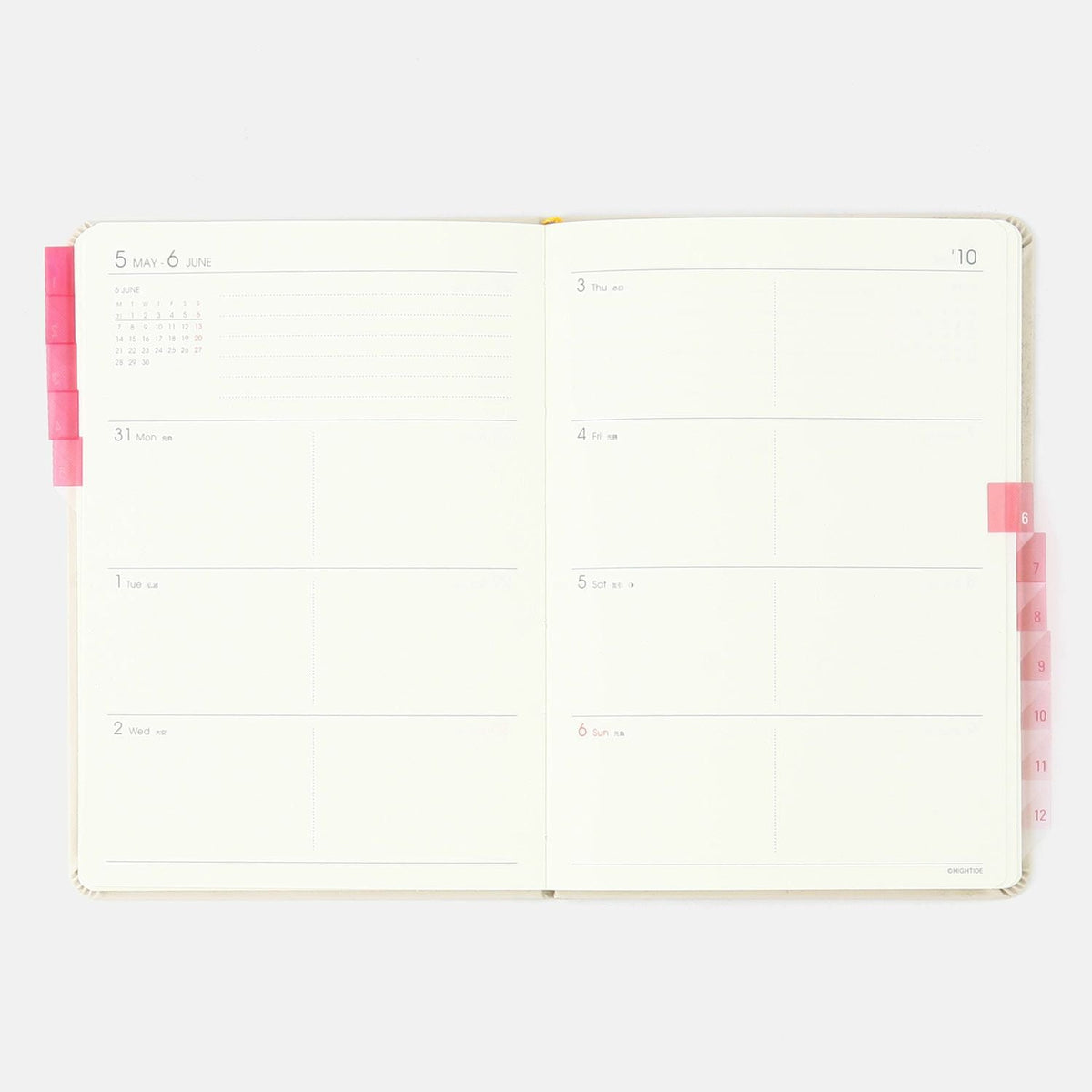 Hightide See-Through Index Stickers, pink, on the edge of a planner